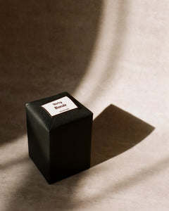 Candle packaging with black paper wrapping