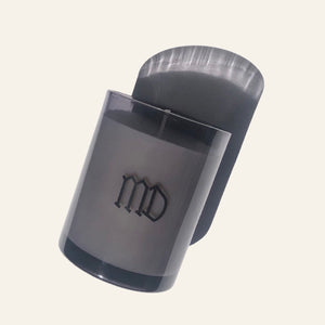 Minimalist MD logo on smoke gray glass vessel